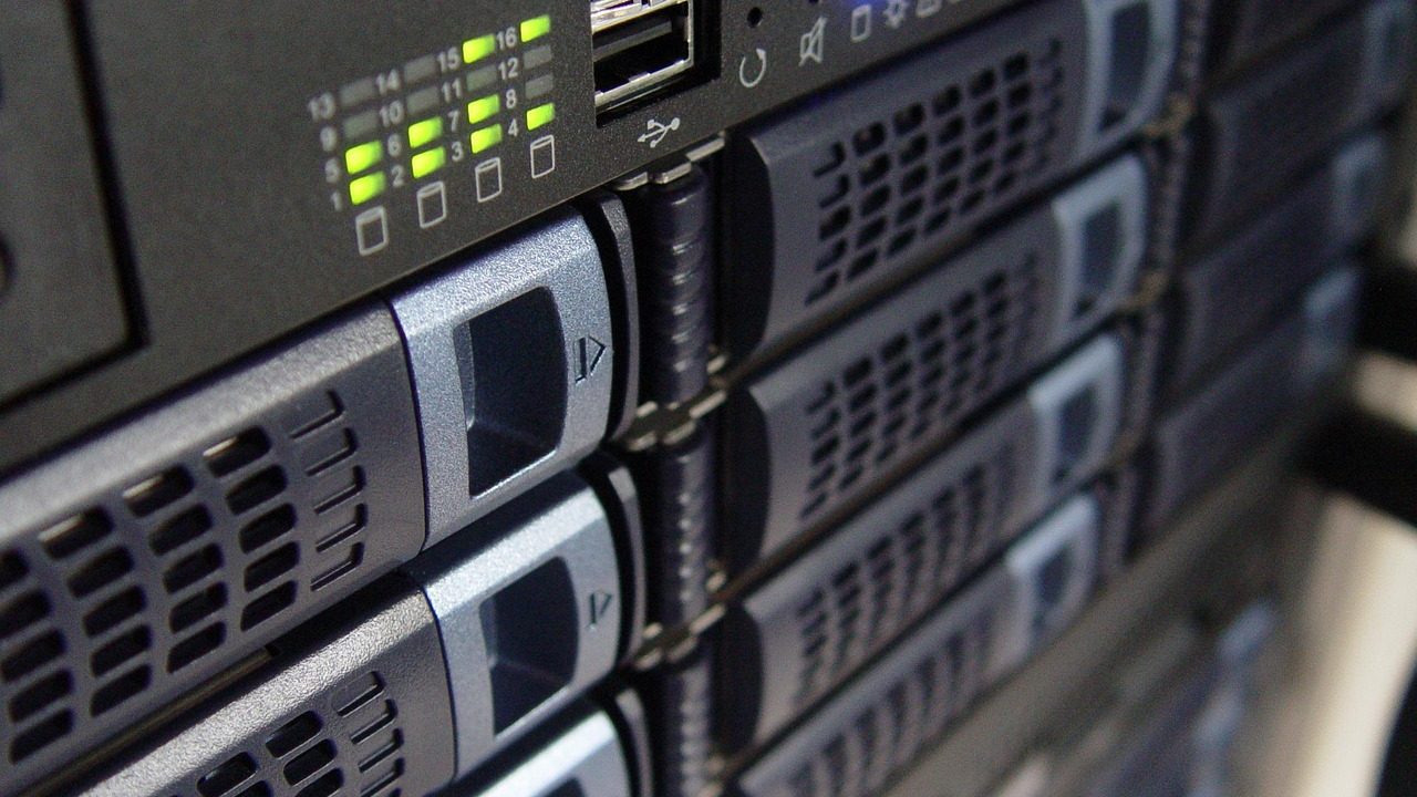 Rows of servers in a dimly lit data center room.