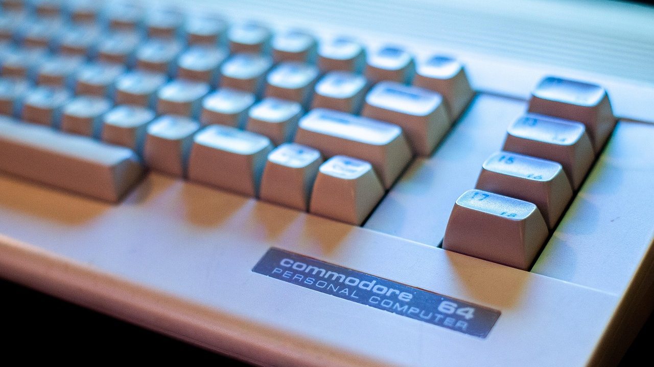 Close-up of the keys on an old beige personal computer keyboard.