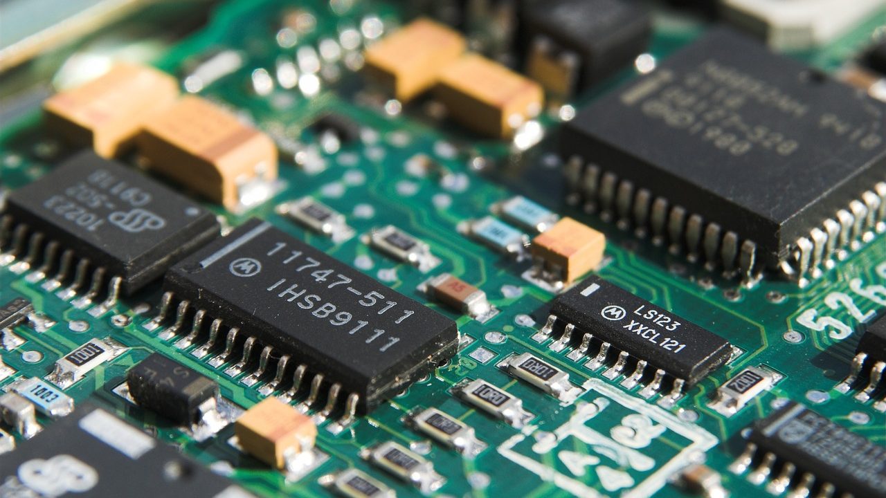Close-up photograph of a computer motherboard showing processor socket and circuit traces.