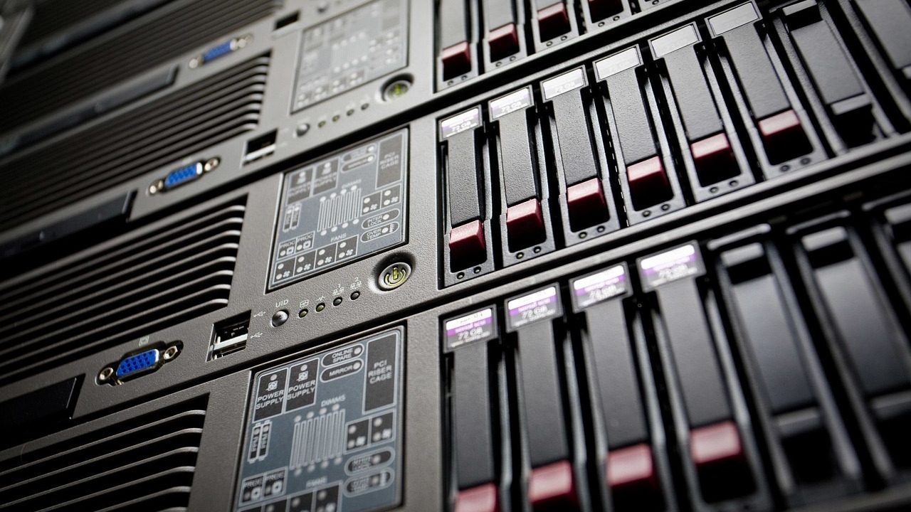Rows of illuminated server racks inside a large data center facility.