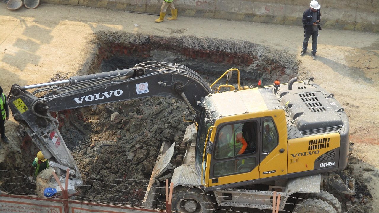 A large tunnel boring machine inside an underground metro construction shaft.