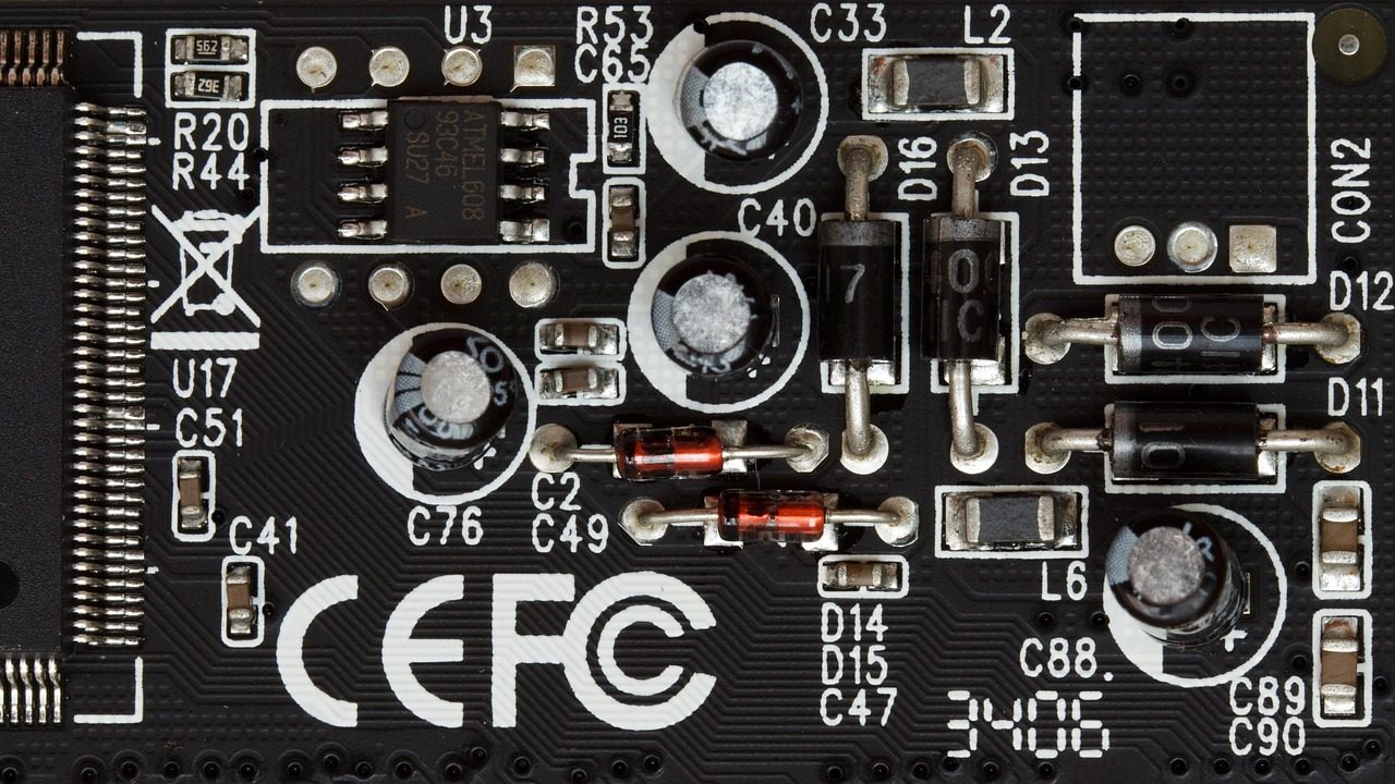 Macro photograph of a green circuit board showing chips, solder points, and copper traces.