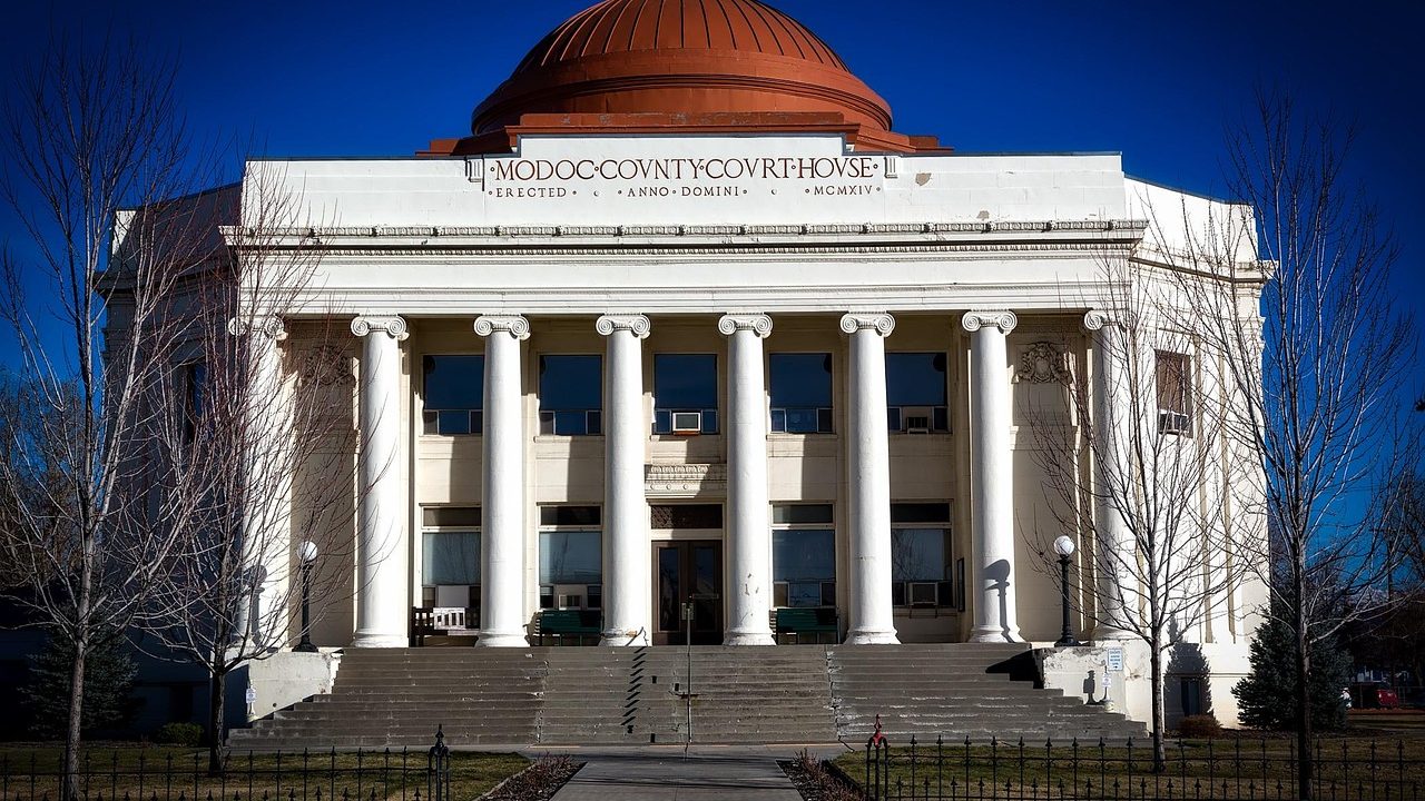 Stone columns flanking the entrance steps of a classical courthouse building.
