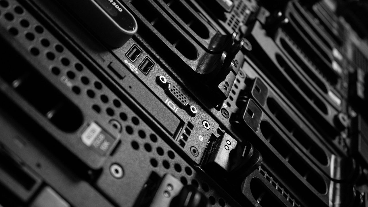 Rows of illuminated server racks inside a large data center facility.