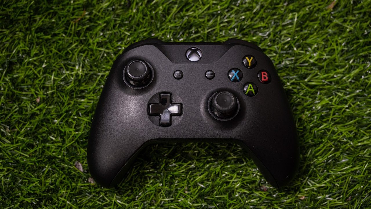 A black game controller resting on a flat surface, photographed close up.