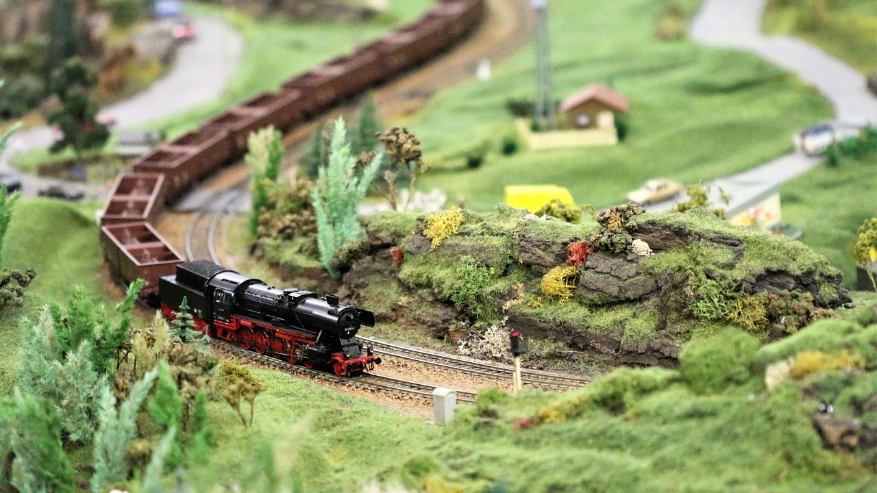 A detailed close-up of a model locomotive on miniature tracks.