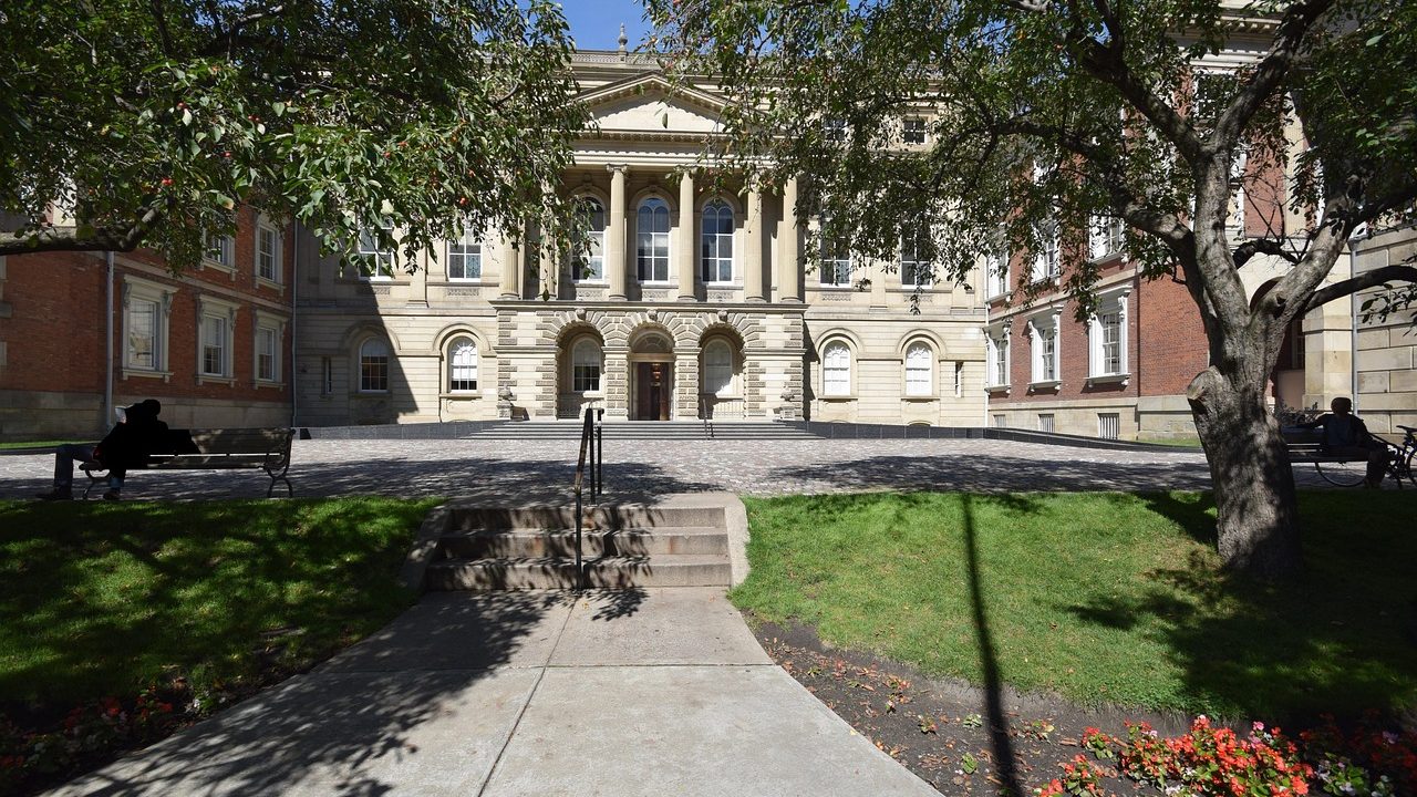 Wide stone steps leading up to a courthouse with tall classical columns.