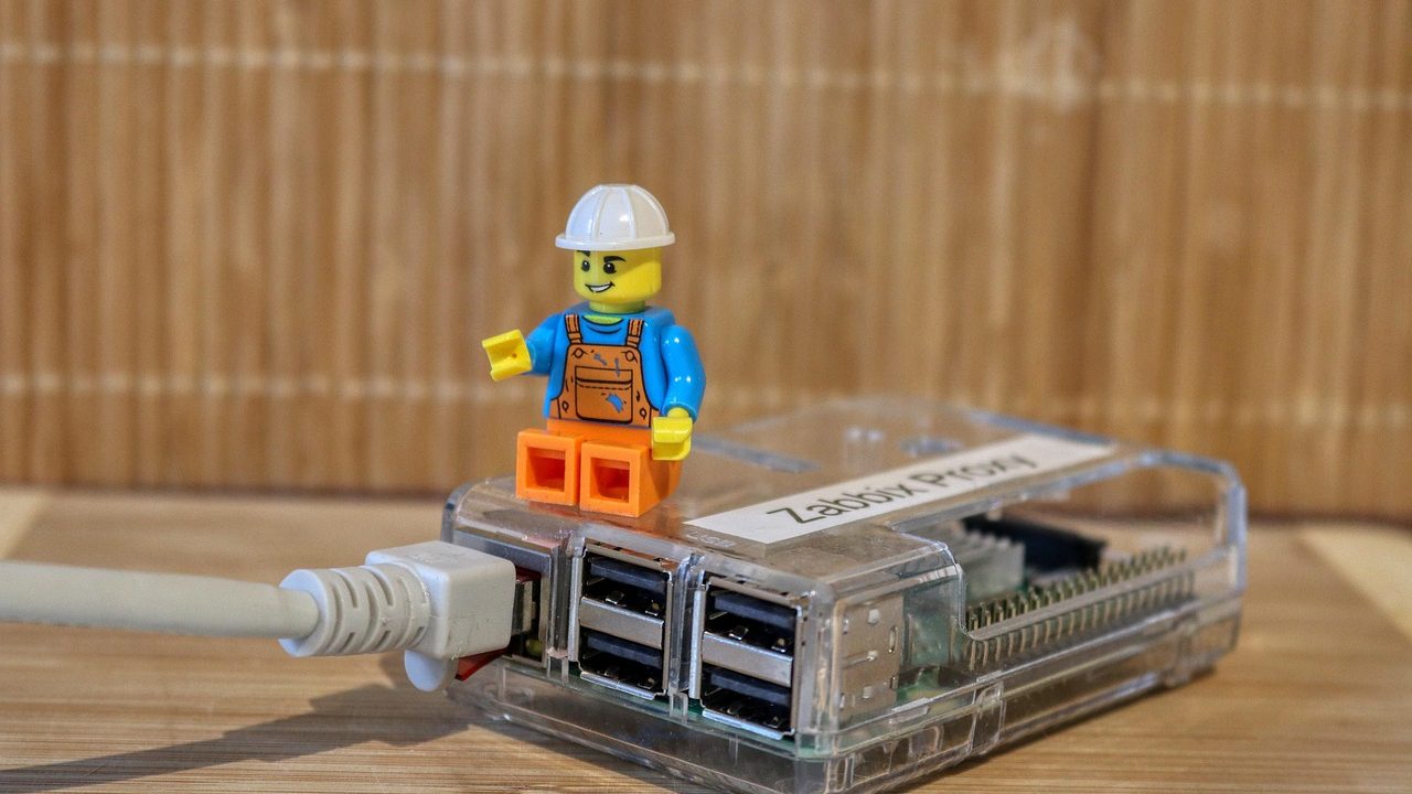 A Raspberry Pi single-board computer connected to colorful jumper wires and small electronic components.