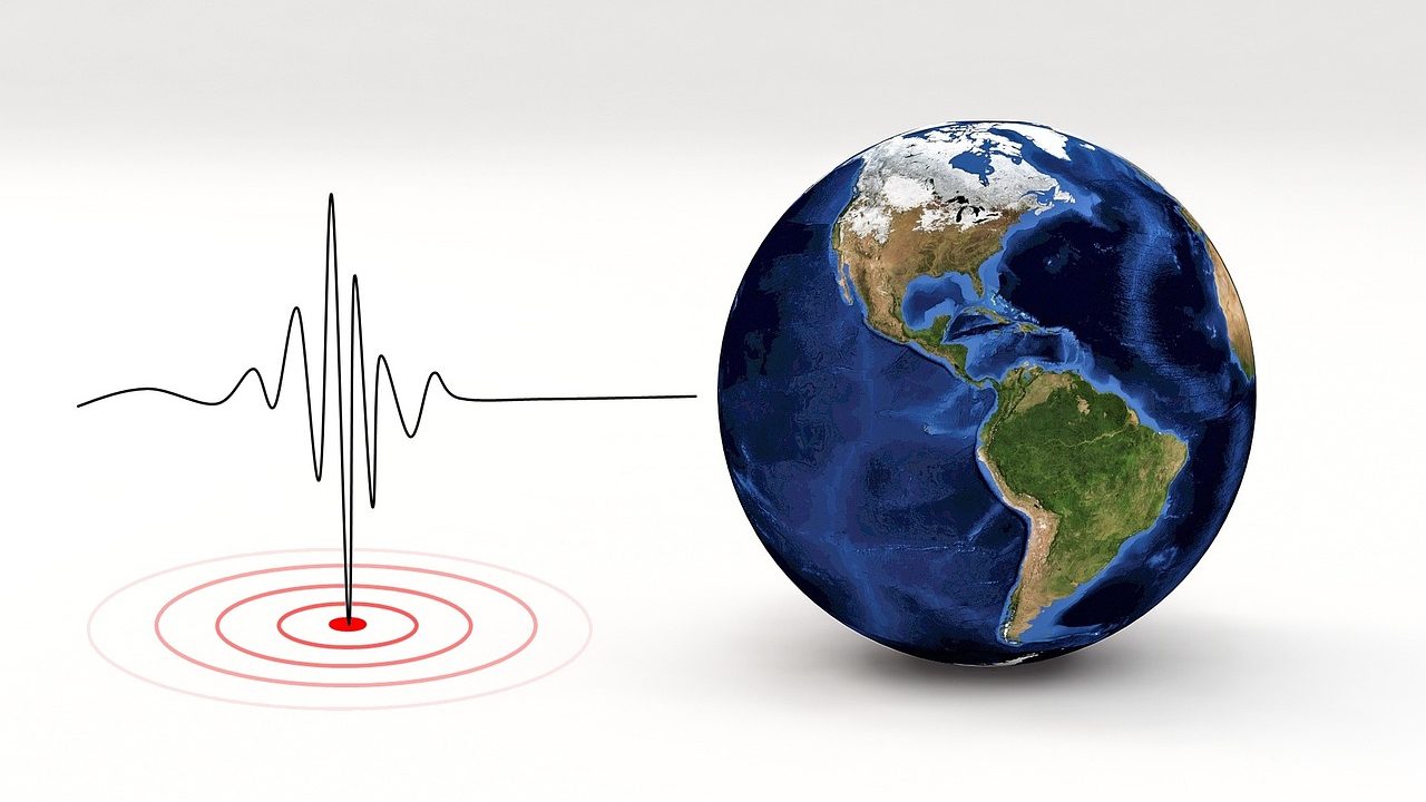 A seismograph needle tracing a wave pattern on a paper roll during seismic activity.