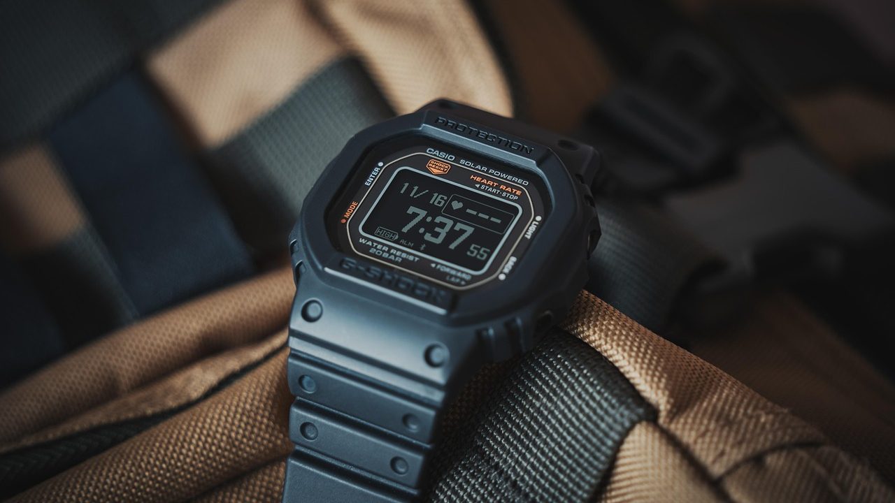 Close-up of a simple digital wristwatch face showing time on a dark display.