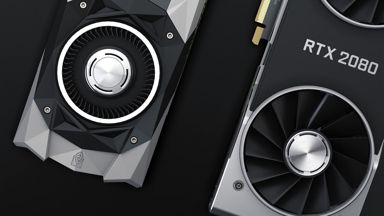 A high-end graphics processing unit with cooling fans resting on a surface.