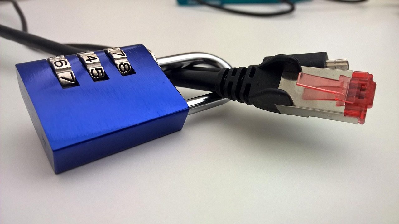 A glowing digital padlock icon overlaid on abstract circuit board patterns.