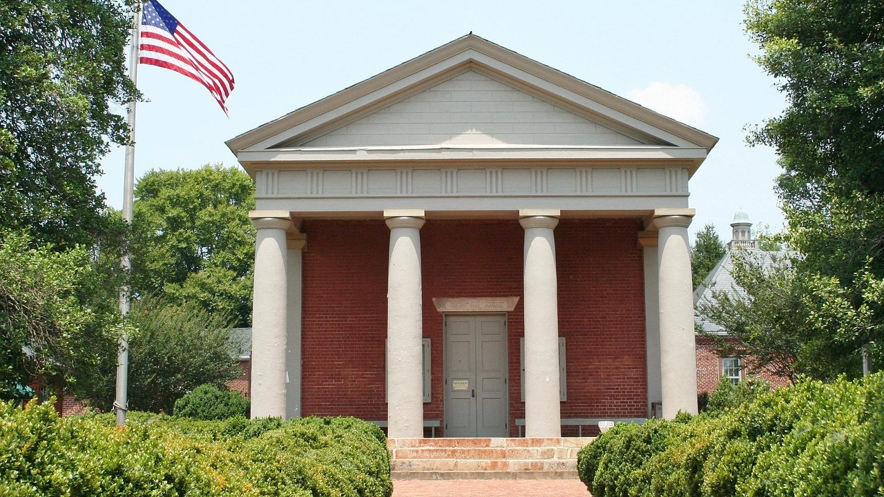 Stone columns and wide steps leading up to a federal courthouse entrance.