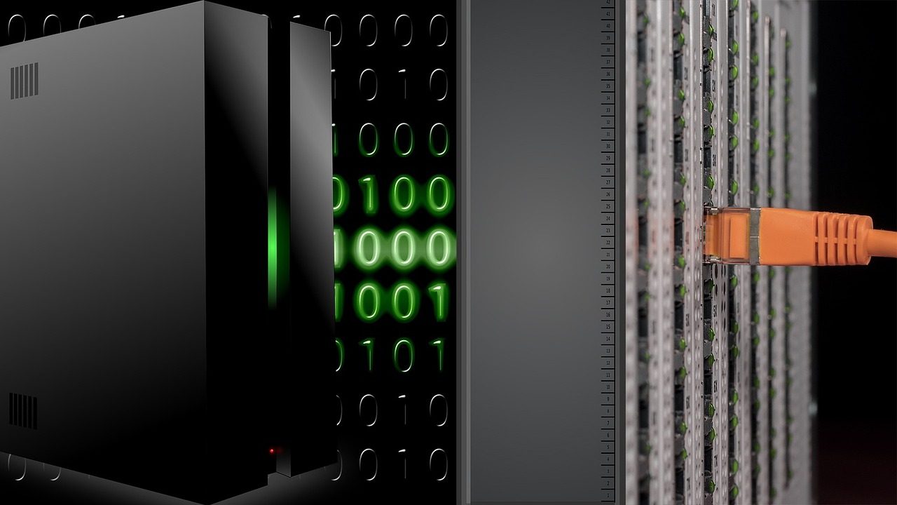 Rows of illuminated server racks glow blue inside a large data center facility.