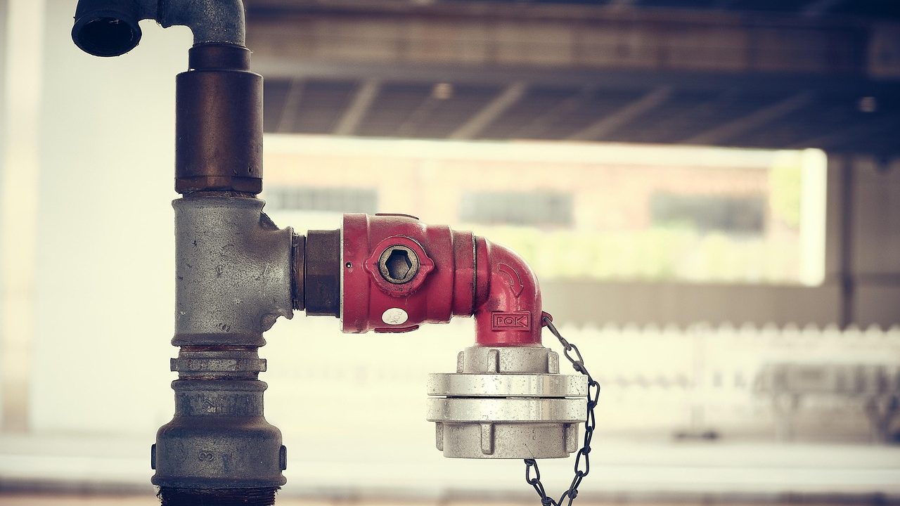 Industrial pipes and valves at a municipal water treatment facility.