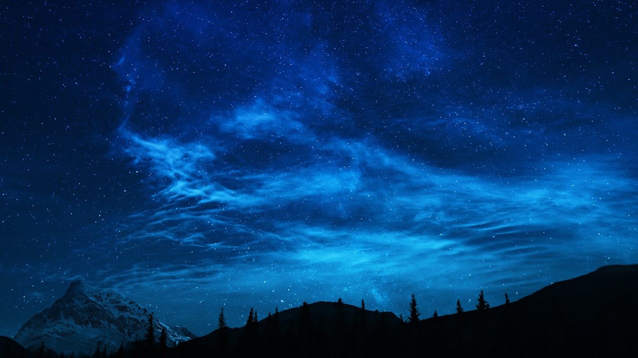 Clear night sky showing bright planets and stars above a dark horizon.