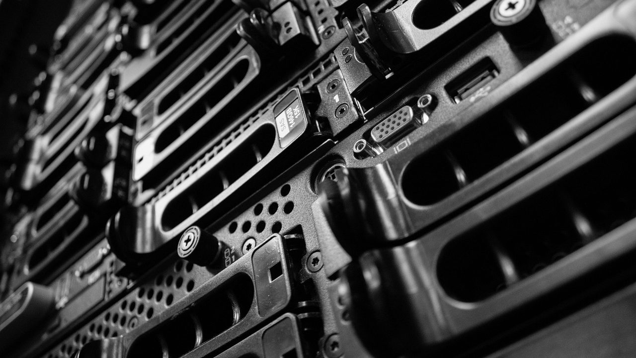 Long rows of illuminated server racks inside a modern data center facility.