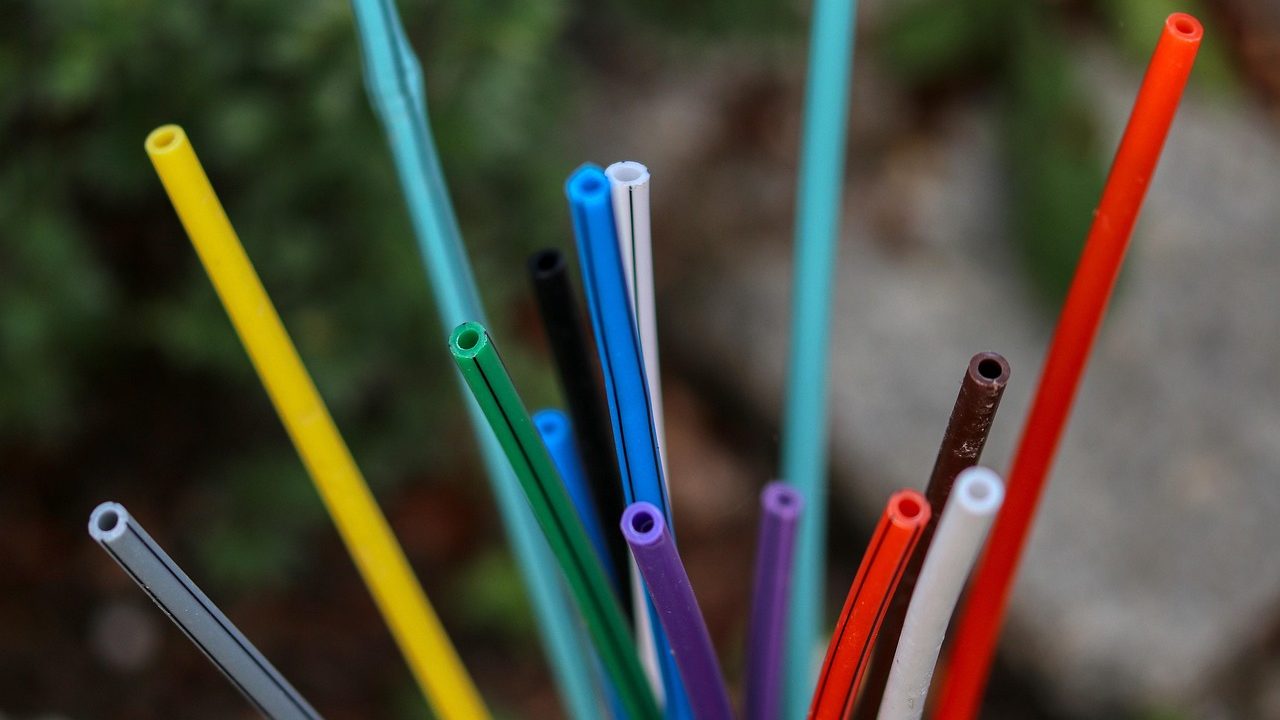 Glowing blue and white fiber optic cables bundled together against a dark background.