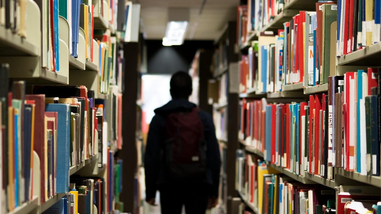 Rows of books fill shelves inside a school library.