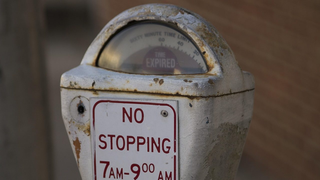 A row of parking meters along an urban street.