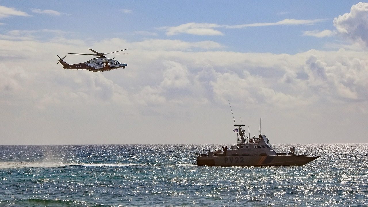 A Coast Guard vessel moving through open ocean water on a search operation.