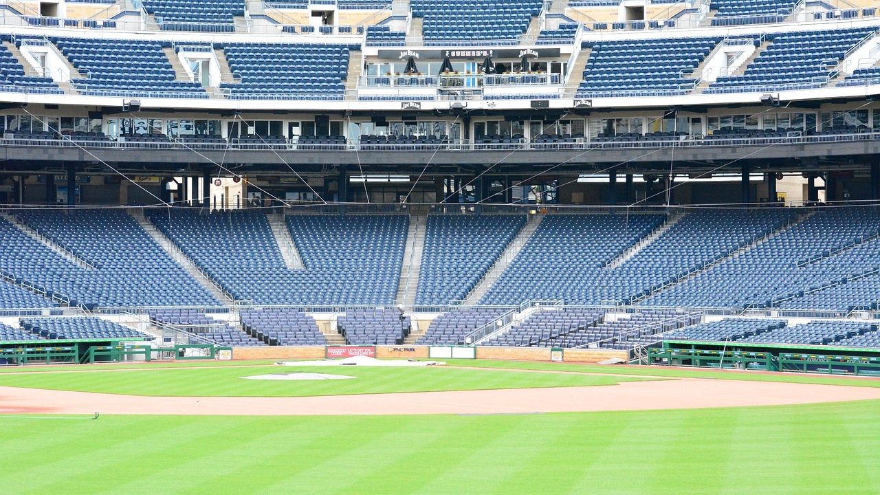 A packed baseball stadium lit up at night with fans in the stands.