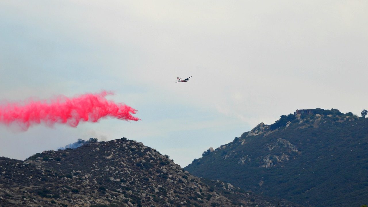 Smoke rising from dry hills during a wildfire in Southern California.